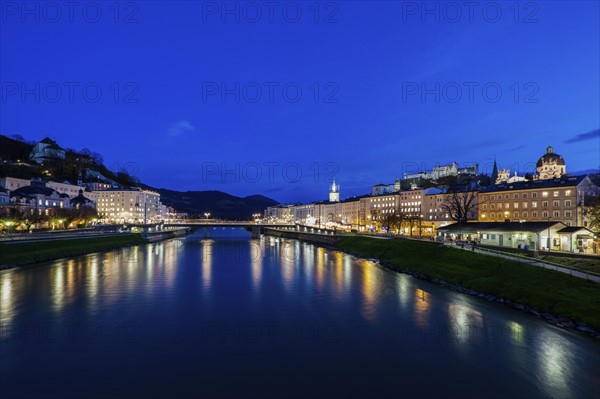 Austria, Salzburg, Illuminated townhouses in riverbank