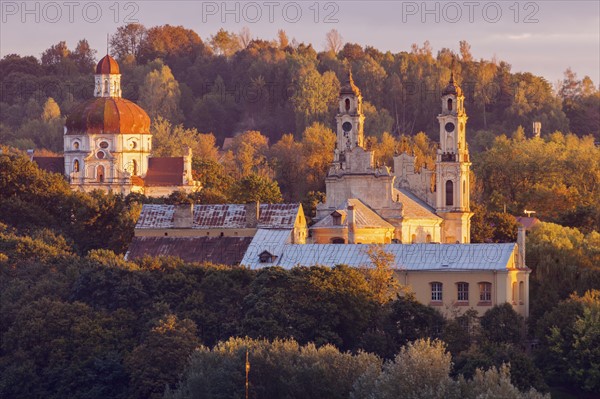 Lithuania, Vilnius, morning view of churches among trees