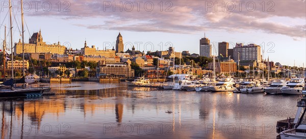 Canada, Quebec, Quebec City, Coastline with marina and buildings reflected in water