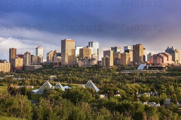 Canada, Alberta, Edmonton, Cityscape with trees in foreground