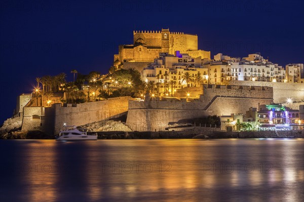 Spain, Valencian Community, Peniscola, Waterfront with fortified wall at night