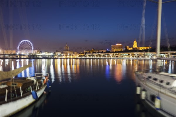 Spain, Andalusia, Seville, Waterfront with sailboats in foreground