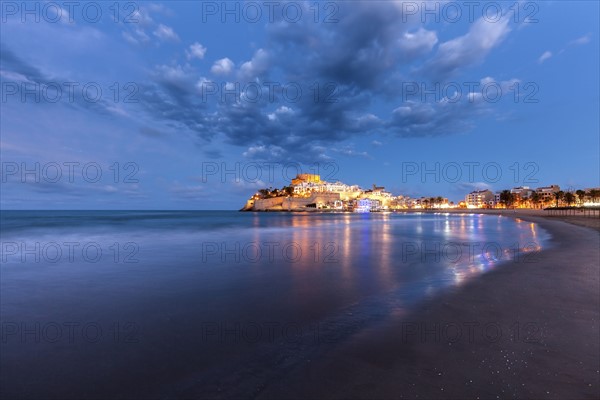 Spain, Valencian Community, Peniscola, Illuminated town by sea