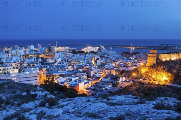 Spain, Andalusia, Almeria, Cityscape with sea at dusk