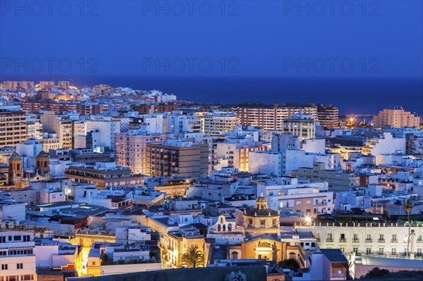 Spain, Andalusia, Almeria, Cityscape with sea at dusk