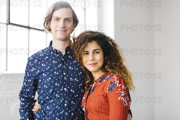 Portrait of couple against window