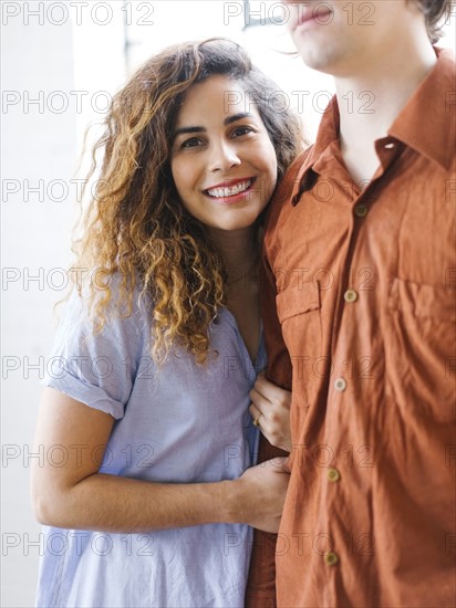 Couple standing against window