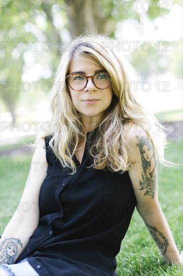 Portrait of woman sitting on grass