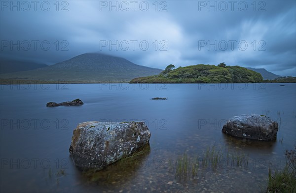 Ireland, Galway County, Connemara, Stones in lake