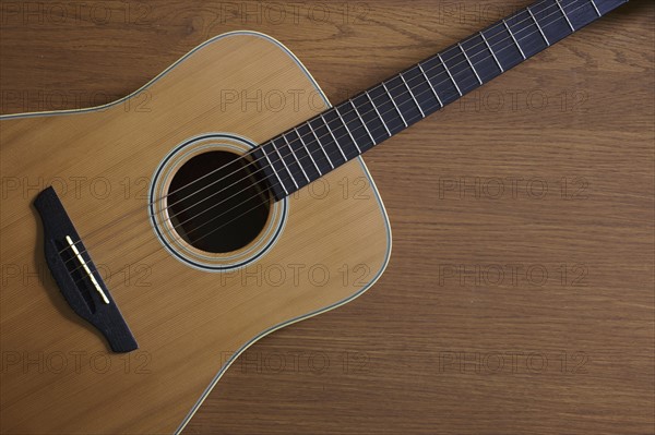 Acoustic guitar lying on floor