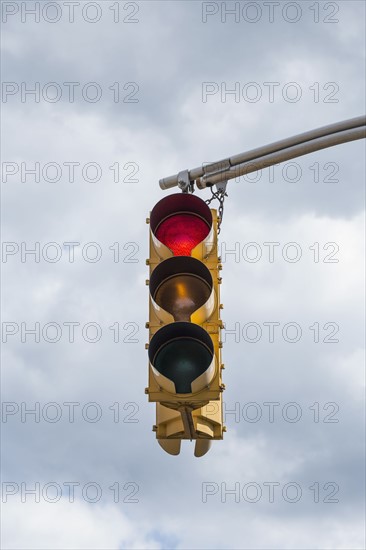 Traffic light against storm clouds