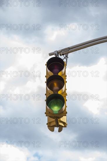 Traffic light against storm clouds