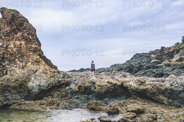 Australia, New South Wales, Woman standing on cliff and looking at view
