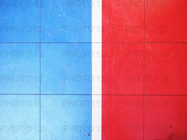 Red and blue tiled floor of basketball court