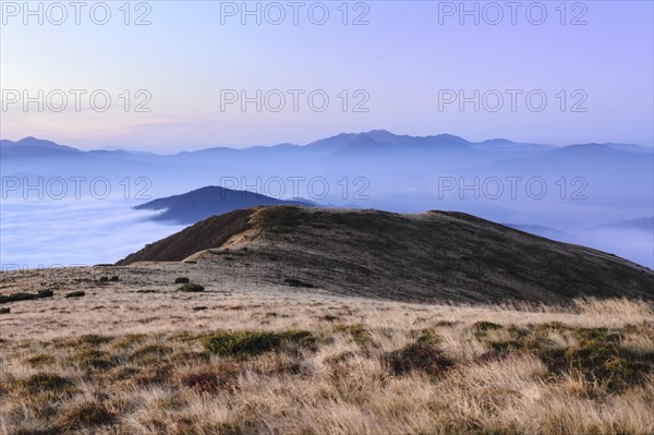 Ukraine, Zakarpattia region, Rakhiv district, Carpathians, Chornohora, Sheshul, Mist over mountains at dawn