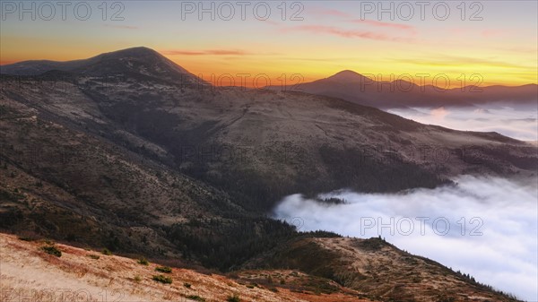 Ukraine, Zakarpattia region, Rakhiv district, Carpathians, Chornohora, Sheshul, Mist over mountains at dawn