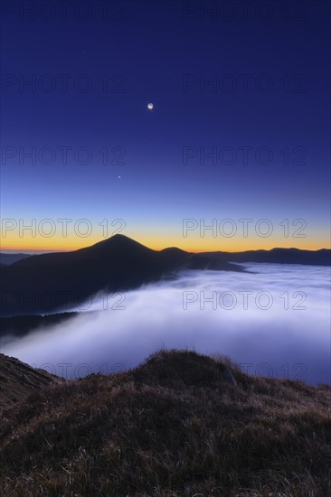 Ukraine, Zakarpattia region, Rakhiv district, Carpathians, Chornohora, Mountain landscape with mist at dusk