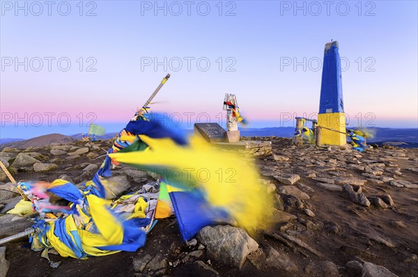 Ukraine, Zakarpattia region, Carpathians, Chornohora, Damaged Ukrainian flag on mountain Hoverla