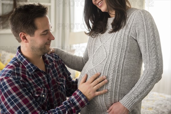 Man touching pregnant partner