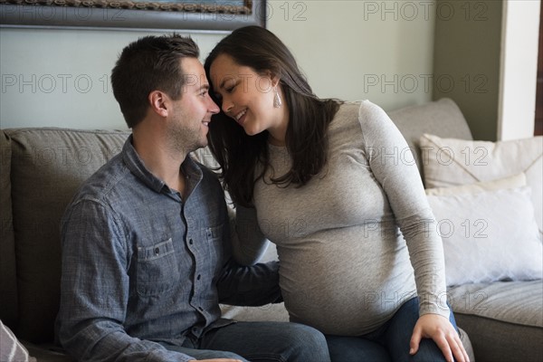 Mid adult couple sitting on sofa