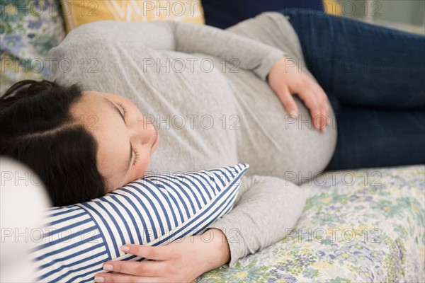 Pregnant woman relaxing at home