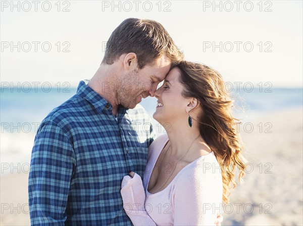 Happy couple in beach, face to face