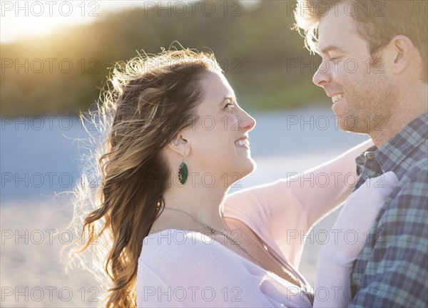 Happy couple in beach, face to face