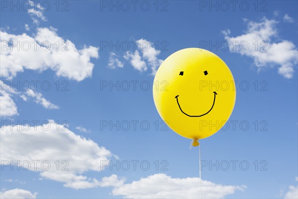 Yellow balloon in blue sky