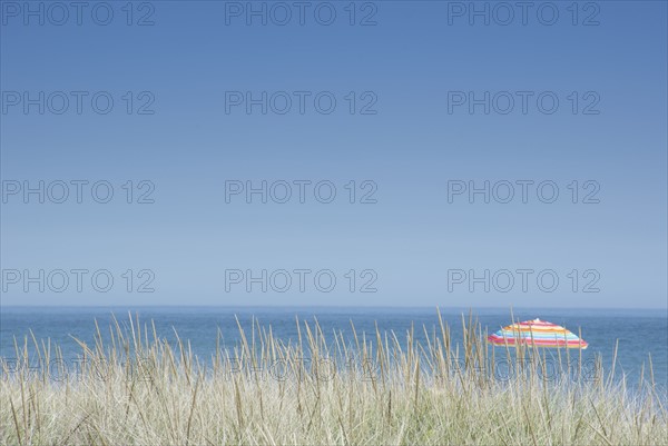 Clear sky above beach umbrella in beach