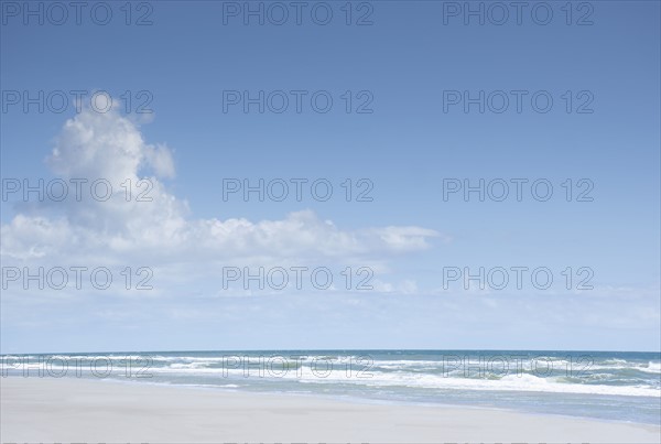 Blue sky and clouds above sea