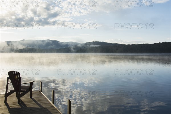 USA, New York State, Adirondack chair on jetty by Lake Placid