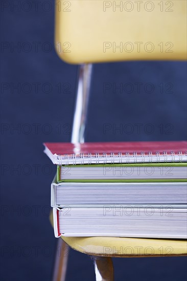 Close up of books stacked on chair