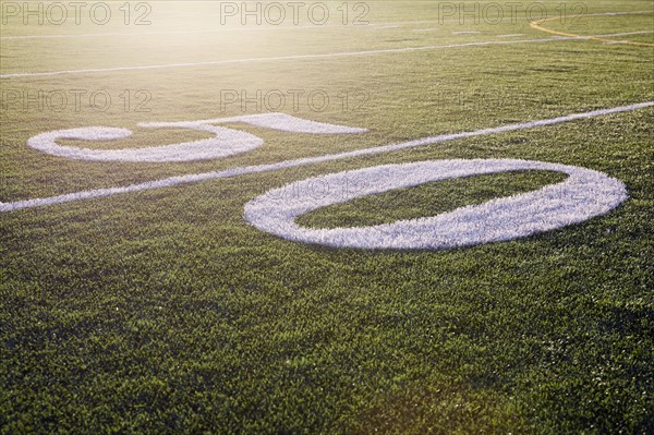 Fifty yard line on green playing field