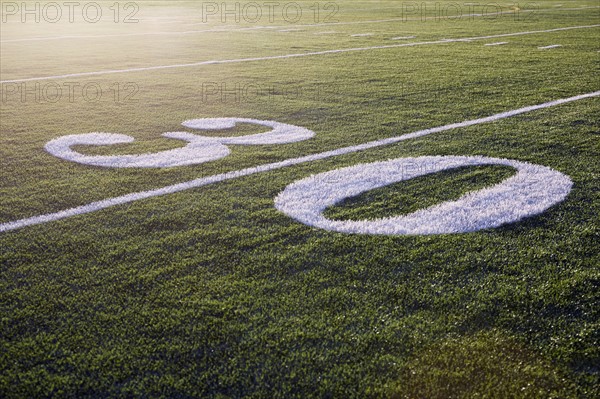 Thirty yard line on green playing field