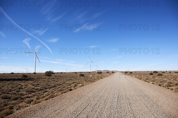 USA, Arizona, Wind turbines and road in arid landscape