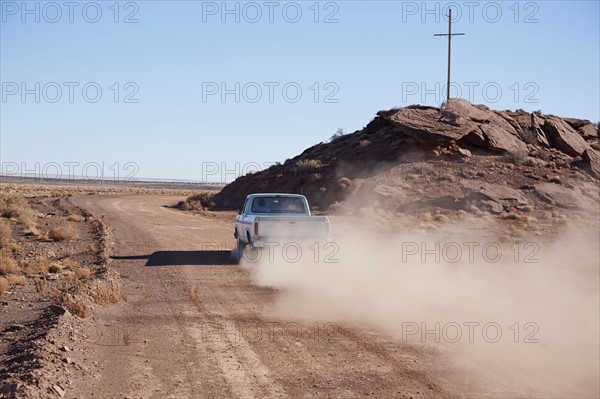 USA, Arizona, Pick up truck on dusty road