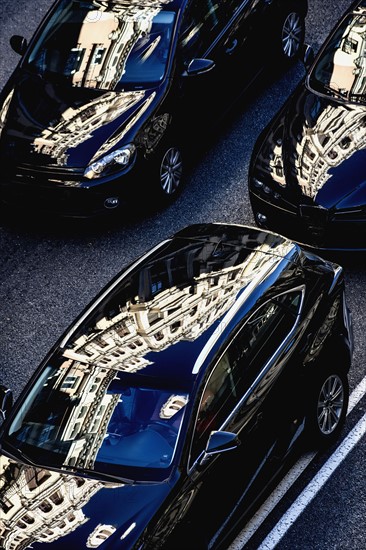 City buildings reflecting in cars on Gran Via