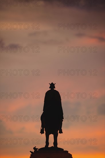 Spain, Seville, Plaza Nueva, Silhouette of equestrian statue of King Fernando III