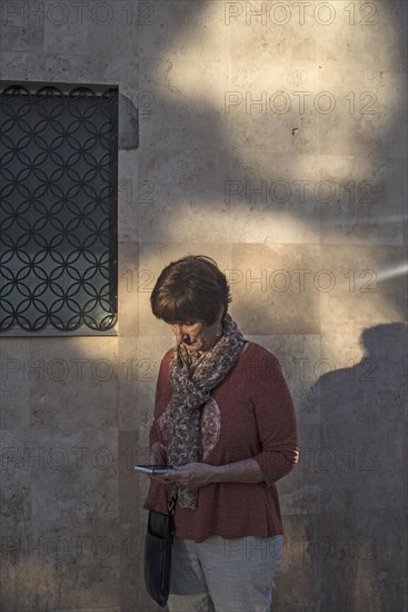 Woman looking at smartphone in street