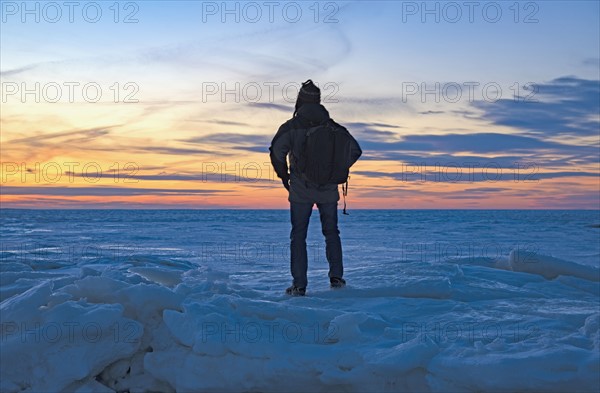 USA, Massachusetts, Eastham, Cape Cod, Rear view of mature man looking at sea at sunset