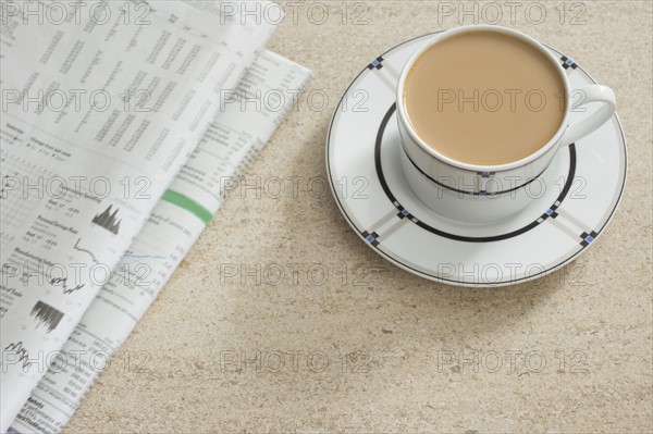 Newspaper and coffee on table