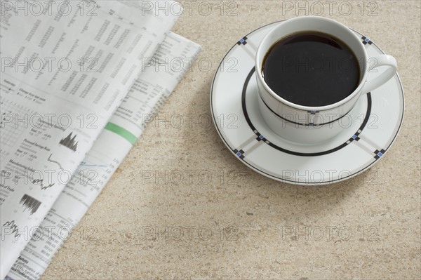 Newspaper and coffee on table