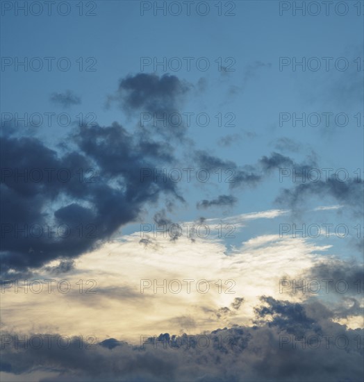 Blue sky with storm clouds at sunset