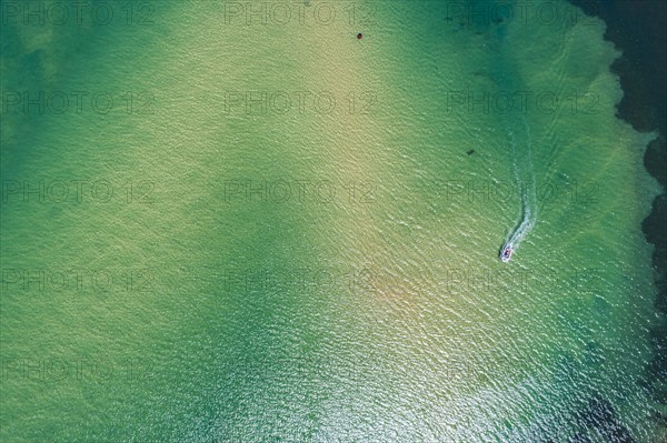 Australia, New South Wales, Narooma, Aerial view of bay and motorboat