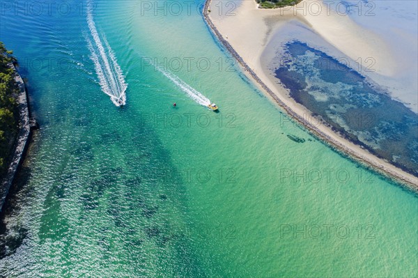 Australia, New South Wales, Narooma, Aerial view of speedboats and inlet