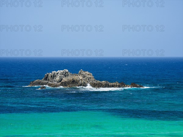 Australia, New South Wales, Bermagui, Wave splashing on rock formation in sea