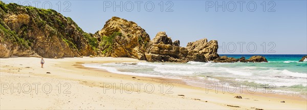 Australia, New South Wales, Bermagui, Woman walking along beach