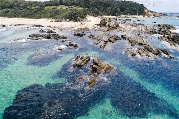 Australia, New South Wales, Bermagui, Sharp rocks in water nera beach