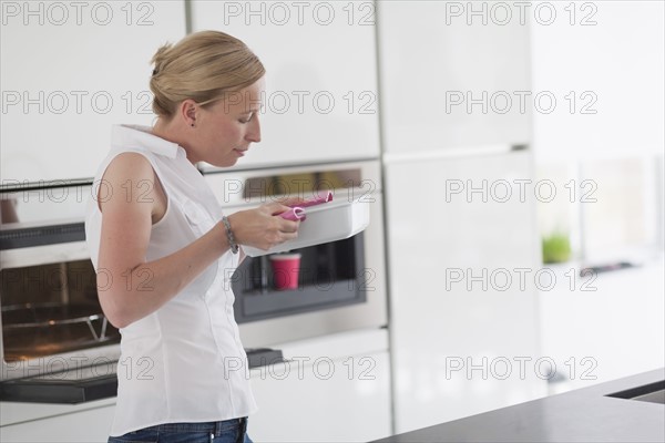 Woman holding hot casserole dish