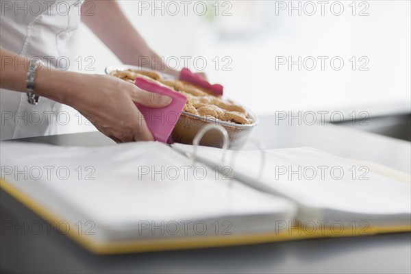 Woman holding hot casserole dish